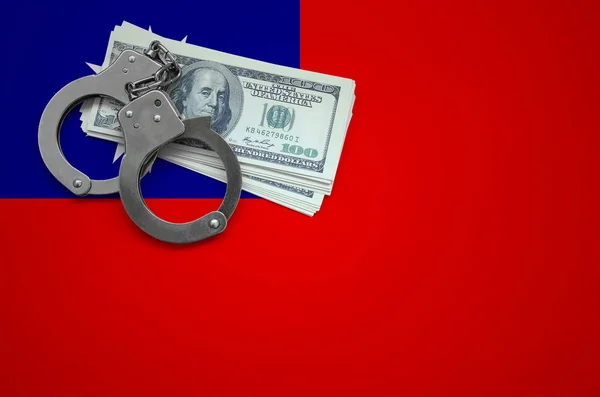 Taiwan flag  with handcuffs and a bundle of dollars. The concept of breaking the law and thieves crimes.