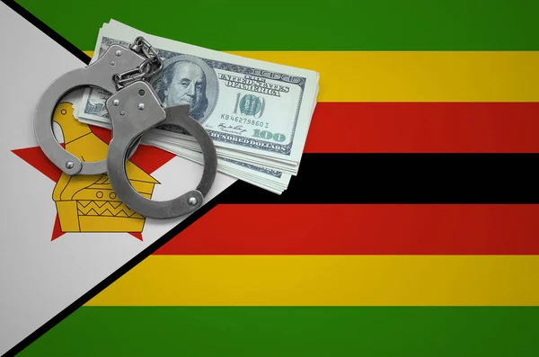 Zimbabwe flag  with handcuffs and a bundle of dollars. The concept of breaking the law and thieves crimes.