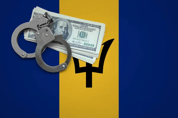 Barbados flag  with handcuffs and a bundle of dollars. The concept of breaking the law and thieves crimes.