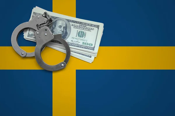 Sweden flag  with handcuffs and a bundle of dollars. The concept of breaking the law and thieves crimes.