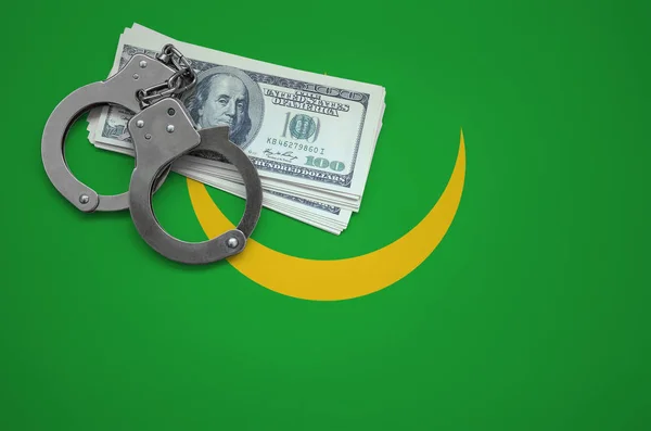 Mauritania flag  with handcuffs and a bundle of dollars. The concept of breaking the law and thieves crimes.