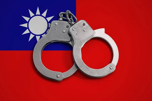 Taiwan flag  and police handcuffs. The concept of observance of the law in the country and protection from crime.