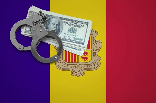 Andorra flag  with handcuffs and a bundle of dollars. The concept of breaking the law and thieves crimes.