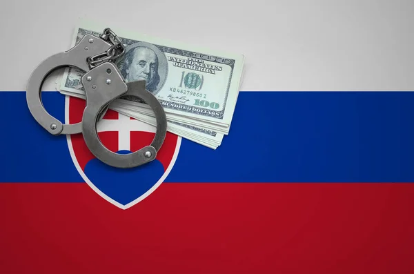 Slovakia flag  with handcuffs and a bundle of dollars. The concept of breaking the law and thieves crimes.