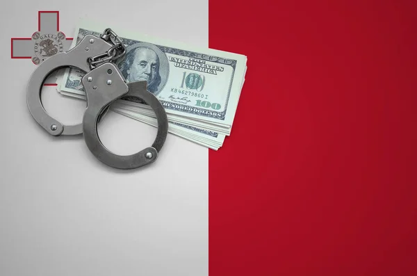 Malta flag  with handcuffs and a bundle of dollars. The concept of breaking the law and thieves crimes.