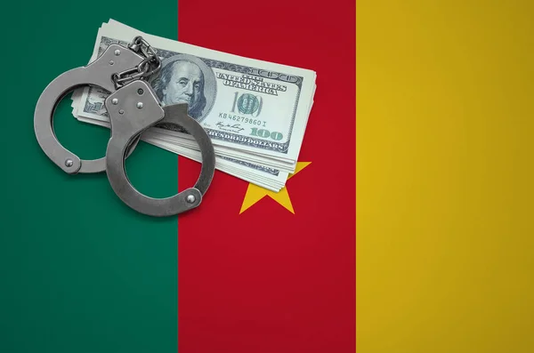 Cameroon flag  with handcuffs and a bundle of dollars. The concept of breaking the law and thieves crimes.