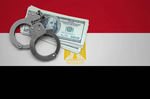 Egypt flag  with handcuffs and a bundle of dollars. The concept of breaking the law and thieves crimes.