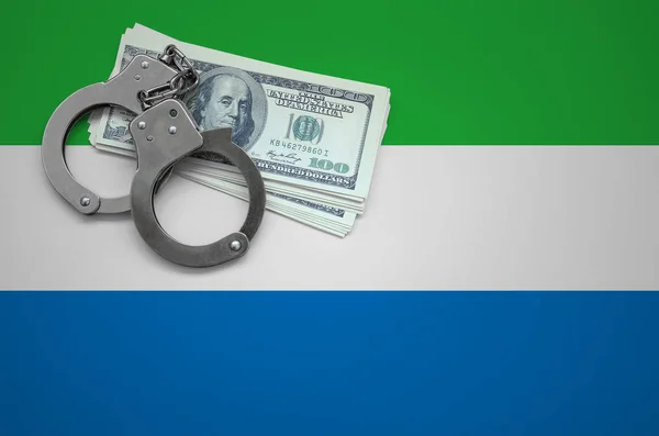 Sierra Leone flag  with handcuffs and a bundle of dollars. The concept of breaking the law and thieves crimes.