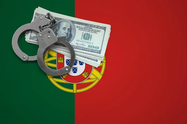 Portugal flag  with handcuffs and a bundle of dollars. The concept of breaking the law and thieves crimes.