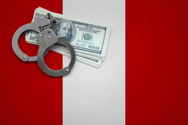 Peru flag  with handcuffs and a bundle of dollars. The concept of breaking the law and thieves crimes.