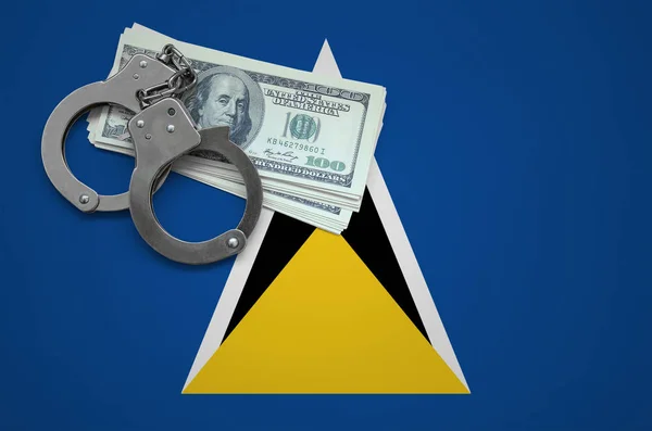 Saint Lucia flag  with handcuffs and a bundle of dollars. The concept of breaking the law and thieves crimes.