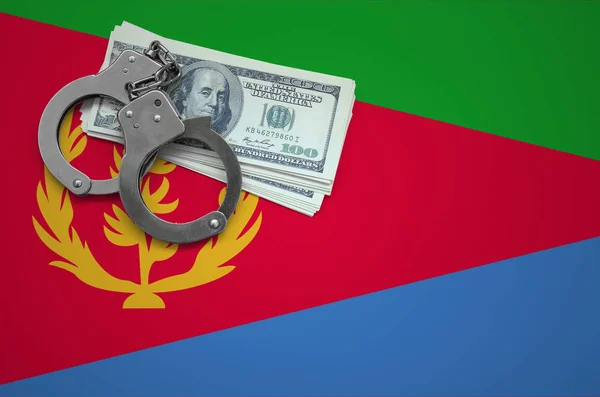 Eritrea flag  with handcuffs and a bundle of dollars. The concept of breaking the law and thieves crimes.