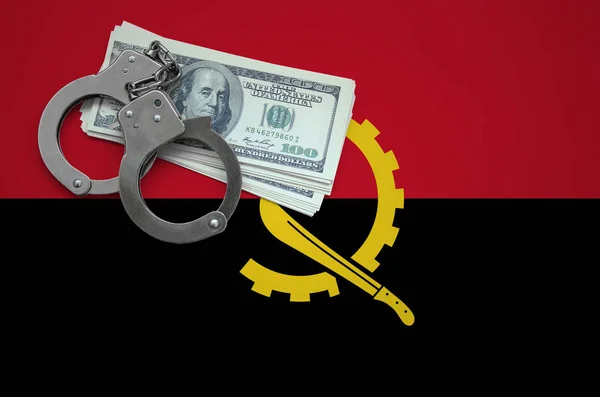 Angola flag  with handcuffs and a bundle of dollars. The concept of breaking the law and thieves crimes.