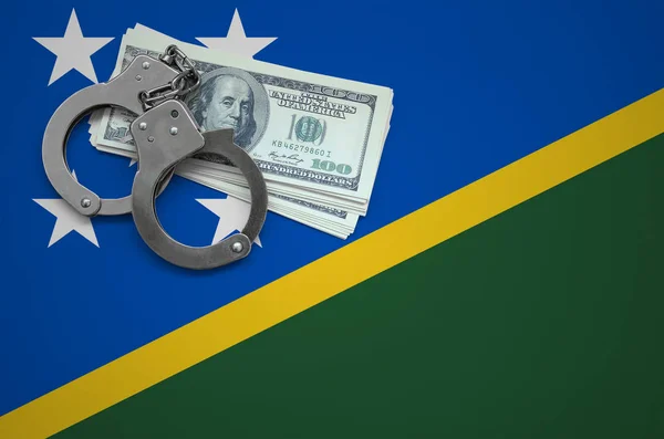 Solomon Islands flag  with handcuffs and a bundle of dollars. The concept of breaking the law and thieves crimes.