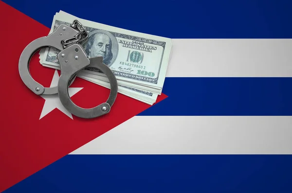 Cuba flag  with handcuffs and a bundle of dollars. The concept of breaking the law and thieves crimes.
