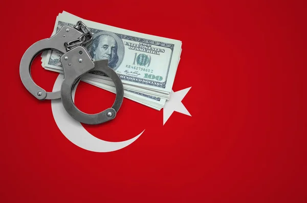Turkey flag  with handcuffs and a bundle of dollars. The concept of breaking the law and thieves crimes.