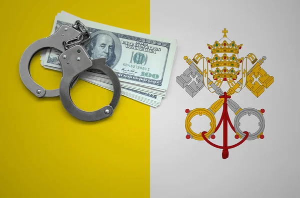 Vatican City State flag  with handcuffs and a bundle of dollars. The concept of breaking the law and thieves crimes.