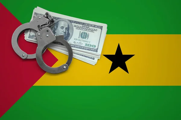 Sao Tome and Principe flag  with handcuffs and a bundle of dollars. The concept of breaking the law and thieves crimes.