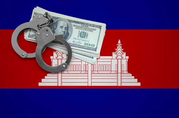 Cambodia flag  with handcuffs and a bundle of dollars. The concept of breaking the law and thieves crimes.