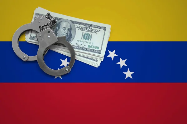 Venezuela flag  with handcuffs and a bundle of dollars. The concept of breaking the law and thieves crimes.