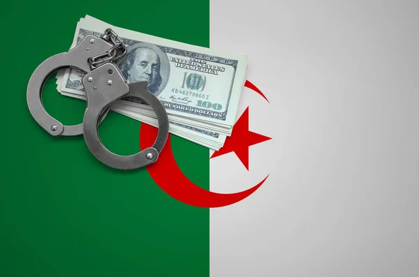 Algeria flag  with handcuffs and a bundle of dollars. The concept of breaking the law and thieves crimes.