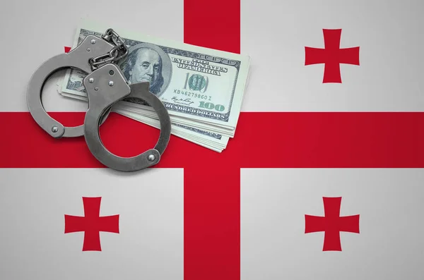 Georgia flag  with handcuffs and a bundle of dollars. The concept of breaking the law and thieves crimes.
