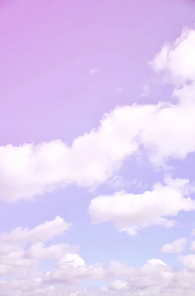 A photo of a bright and shiny blue sky with fluffy and dense white clouds of different sizes and shapes. Beautiful sky on a clear spring afternoon