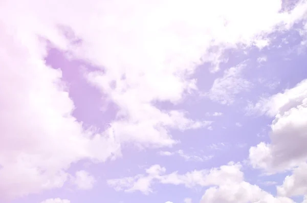 A photo of a bright and shiny blue sky with fluffy and dense white clouds of different sizes and shapes. Beautiful sky on a clear spring afternoon