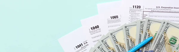 Formları yalan yüz dolar faturaları ve ışık mavi zemin üzerine mavi kalem yakın vergi. Gelir vergisi beyannamesi.
