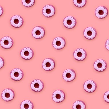 Birçok küçük plastik donuts bir pastel renkli arka plan üzerinde yatıyor. Düz yatıyordu en az desen. Üstten görünüm