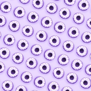 Birçok küçük plastik donuts bir pastel renkli arka plan üzerinde yatıyor. Düz yatıyordu en az desen. Üstten görünüm