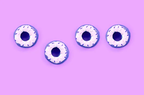 Many small plastic donuts lies on a pastel colorful background. Flat lay minimal pattern. Top view — Stock Photo, Image