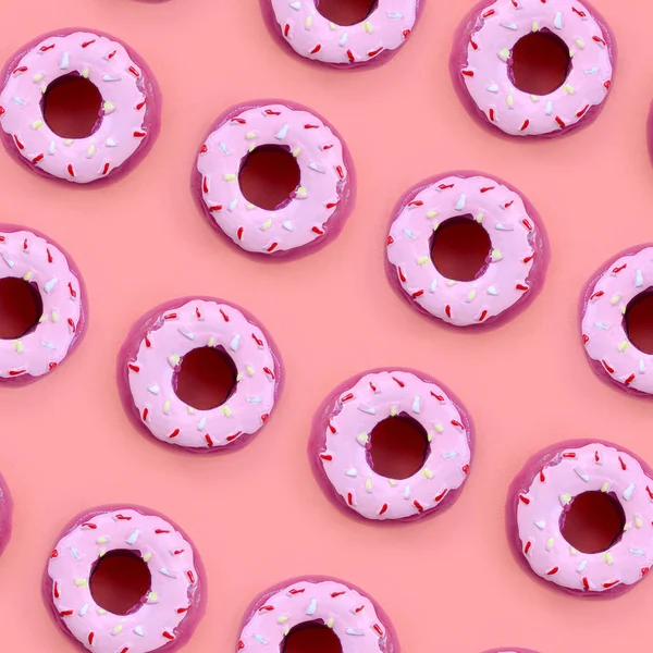 Muchos pequeños donuts de plástico se encuentra en un fondo de colores pastel. Piso establecer un patrón mínimo. Vista superior — Foto de Stock