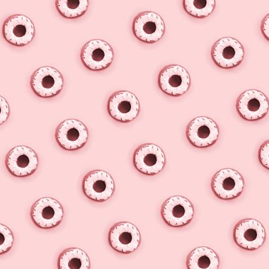 Birçok küçük plastik donuts bir pastel renkli arka plan üzerinde yatıyor. Düz yatıyordu en az desen. Üstten görünüm