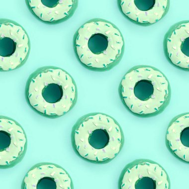 Birçok küçük plastik donuts bir pastel renkli arka plan üzerinde yatıyor. Düz yatıyordu en az desen. Üstten görünüm