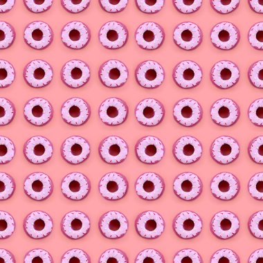 Birçok küçük plastik donuts bir pastel renkli arka plan üzerinde yatıyor. Düz yatıyordu en az desen. Üstten görünüm
