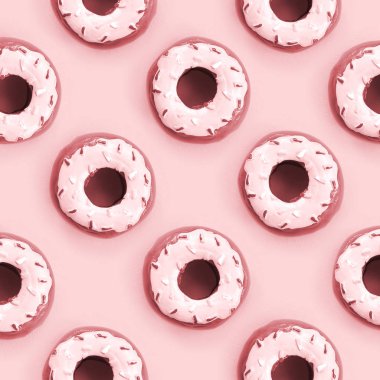 Birçok küçük plastik donuts bir pastel renkli arka plan üzerinde yatıyor. Düz yatıyordu en az desen. Üstten görünüm