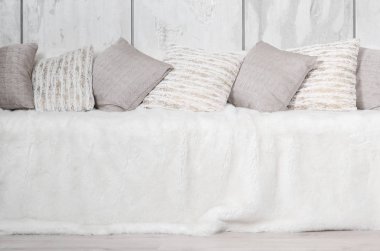 Kanepede bir mermer duvar arka planı büyük bir peluş örtü ile kaplıdır birçok yastıklar yalan