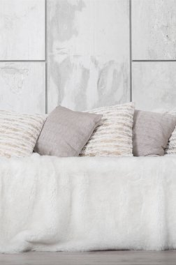 Kanepede bir mermer duvar arka planı büyük bir peluş örtü ile kaplıdır birçok yastıklar yalan
