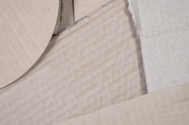 Bir sürü ev aletleri ve posta paketleri taşıma kutuları yapmak için kullanılan bej karton kağıt arka plan görüntüsü. Karton doku