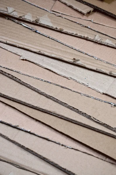 Bir sürü ev aletleri ve posta paketleri taşıma kutuları yapmak için kullanılan bej karton kağıt arka plan görüntüsü. Karton doku