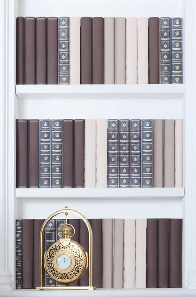 Large White Bookshelf Many Books Different Colors Golden Clock — Stock Photo, Image