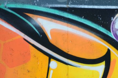 Grafiti çizimler parçası. Eski duvar boya lekeleri sokak sanatı kültür tarzı ile dekore edilmiştir. Renkli arka plan doku sıcak tonları içinde.