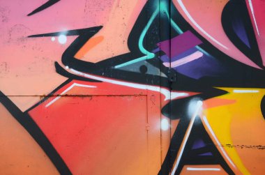 Grafiti çizimler parçası. Eski duvar boya lekeleri sokak sanatı kültür tarzı ile dekore edilmiştir. Renkli arka plan doku sıcak tonları içinde.