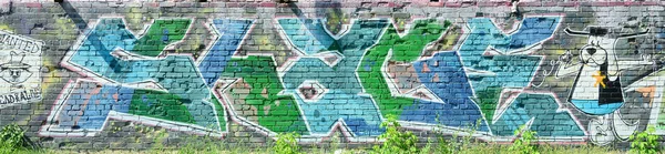 落書き図面のフラグメント 古い壁塗料の汚れストリート アート文化のスタイルで飾られています 緑のトーンの色の背景のテクスチャ ロイヤリティフリーのストック画像