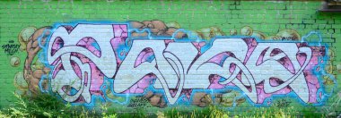 Grafiti çizimler parçası. Eski duvar boya lekeleri sokak sanatı kültür tarzı ile dekore edilmiştir. Yeşil tonlarında renkli arka plan doku.