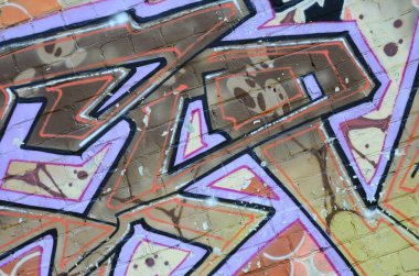Grafiti çizimler parçası. Eski duvar boya lekeleri sokak sanatı kültür tarzı ile dekore edilmiştir. Renkli arka plan doku sıcak tonları içinde.