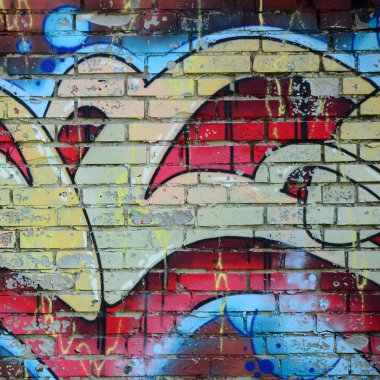 Grafiti çizimler parçası. Eski duvar boya lekeleri sokak sanatı kültür tarzı ile dekore edilmiştir. Renkli arka plan doku sıcak tonları içinde.