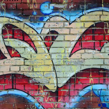 Grafiti çizimler parçası. Eski duvar boya lekeleri sokak sanatı kültür tarzı ile dekore edilmiştir. Renkli arka plan doku sıcak tonları içinde.