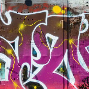 Grafiti çizimler parçası. Eski duvar boya lekeleri sokak sanatı kültür tarzı ile dekore edilmiştir. Renkli arka plan doku sıcak tonları içinde.